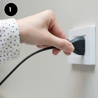 Hand plugging in EpiCooler portable air conditioner into wall socket – step 1 no installation needed
